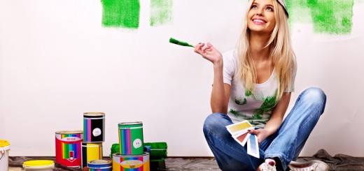 Woman paint wall at home.